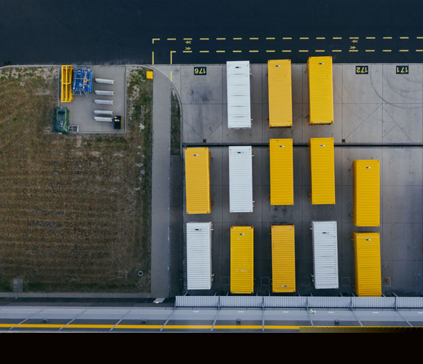 Yellow and white containers from above in a parking lot Yellow and white containers from above in a parking lot
