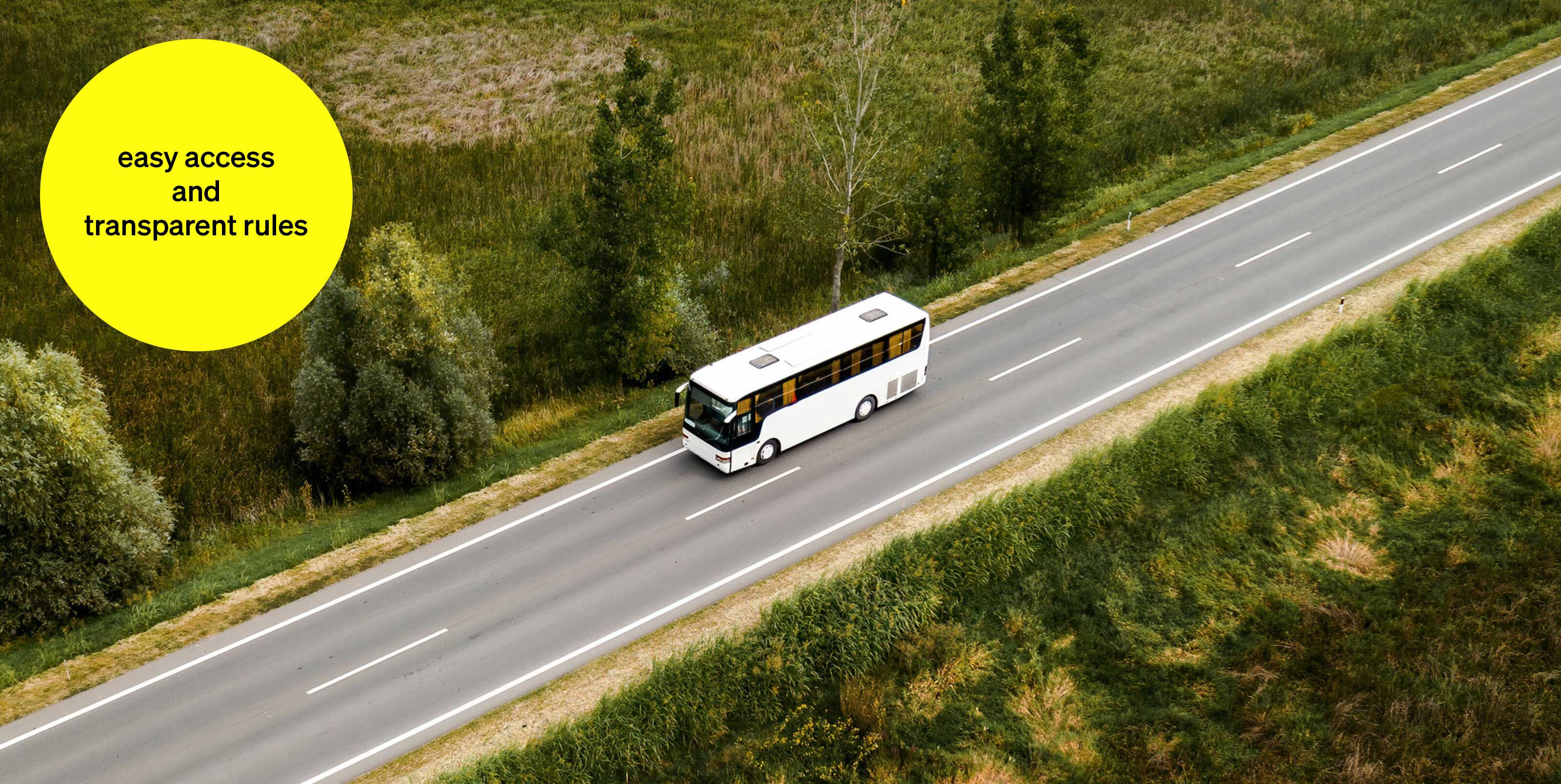 White bus driving on an open road through green landscape - text module in round tile: easy access and transparent rules White bus driving on an open road through green landscape - text module in round tile: easy access and transparent rules