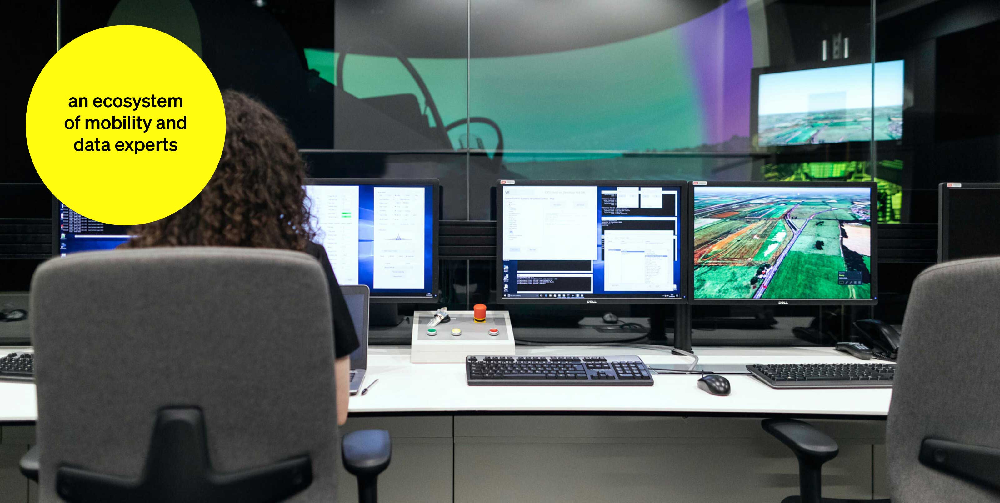 Woman sitting in control room in a video studio - text module in round tile: An ecosystem of mobility and data experts Woman sitting in control room in a video studio - text module in round tile: An ecosystem of mobility and data experts