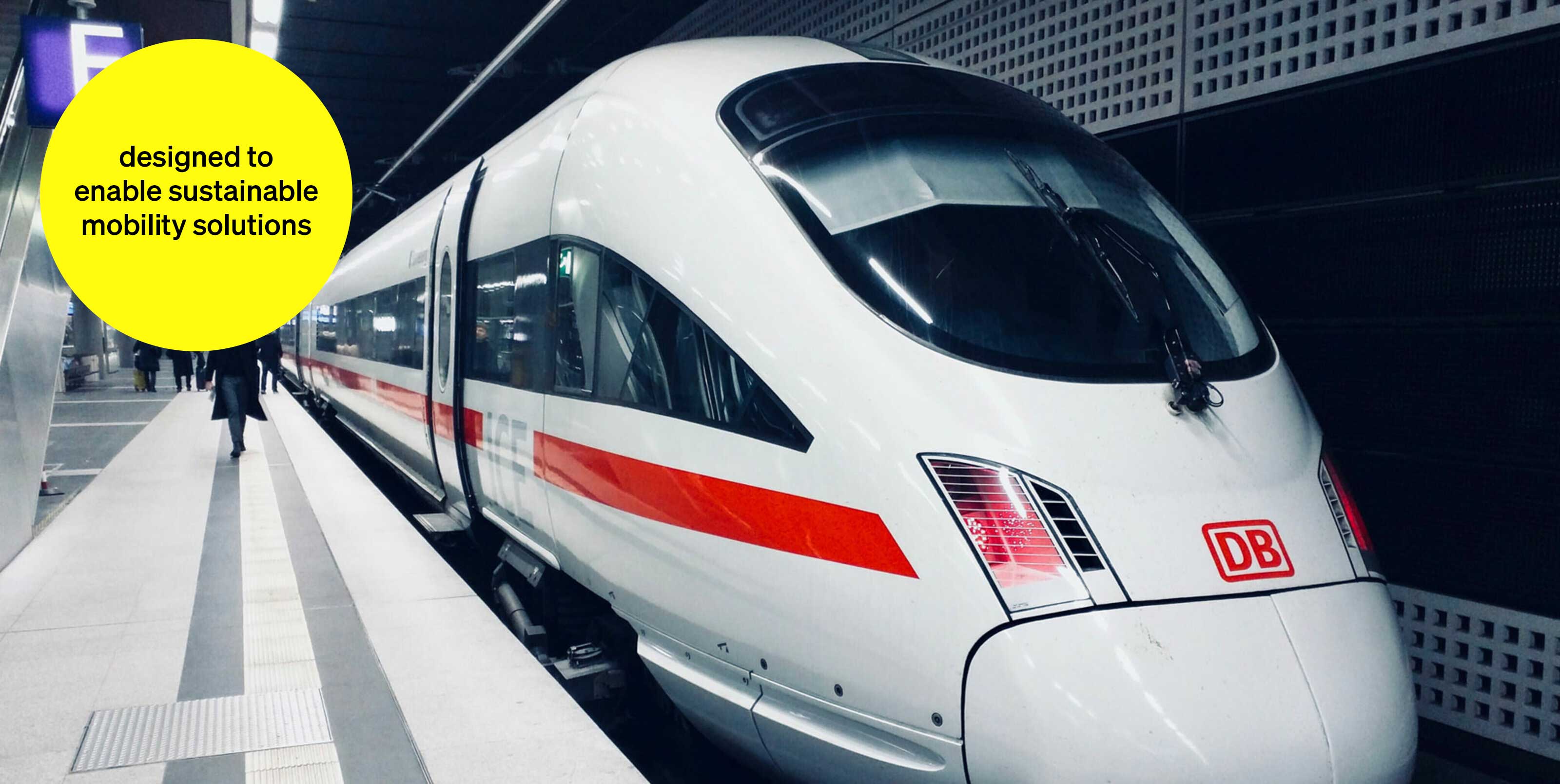 ICE in an underground station with passersby - text module in round tile: We enable sustainable mobility solutions ICE in an underground station with passersby - text module in round tile: We enable sustainable mobility solutions